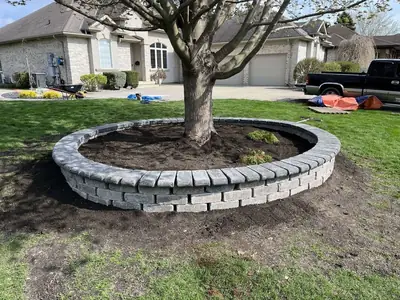 Circular stone border built around a front-yard tree