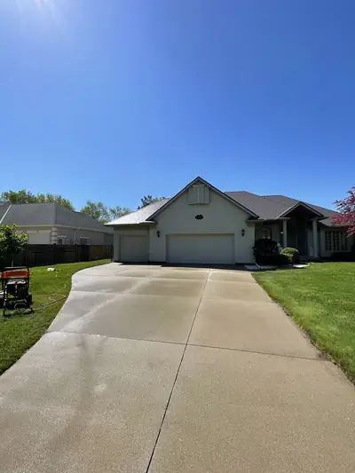 Front of a home and concrete driveway after exterior washing