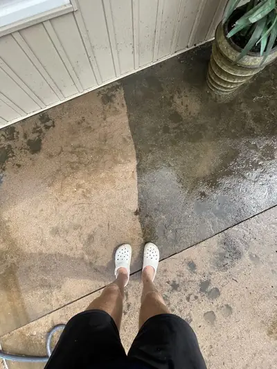 Concrete patio part-way through a pressure wash