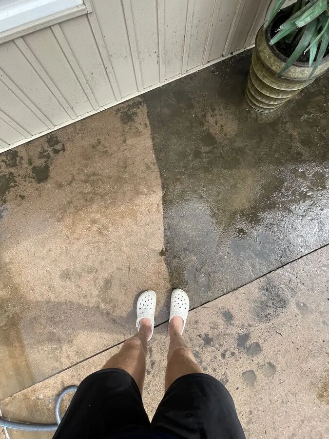 Concrete patio part-way through a pressure wash