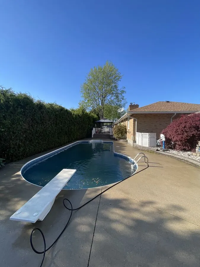 Concrete pool deck pressure washed for the season