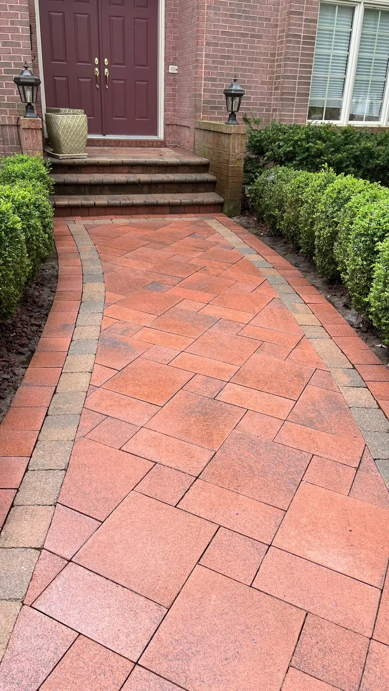 The same interlock walkway after cleaning, with its red colour restored