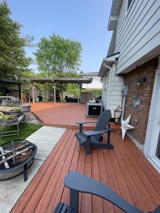 Red-stained deck with Adirondack chairs after washing